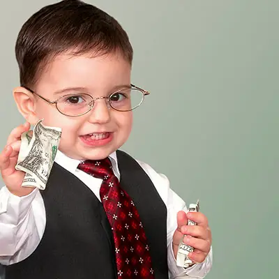 Image of toddler in a suit holding money