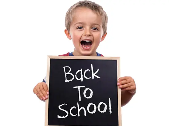 image of child holding back-to-shool chalkboard