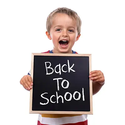 Image of child holding a chalkboard that reads BACK TO SCHOOL
