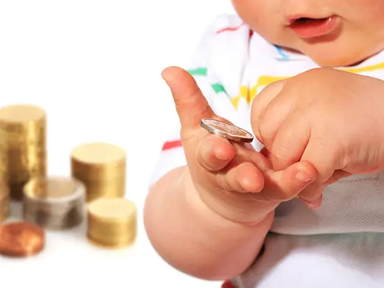 Image of infant holding money