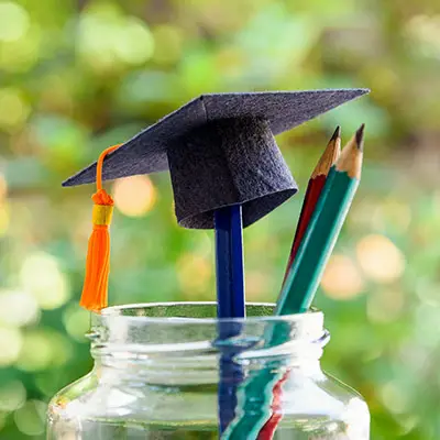 Image of jar of pencils with graduation cap