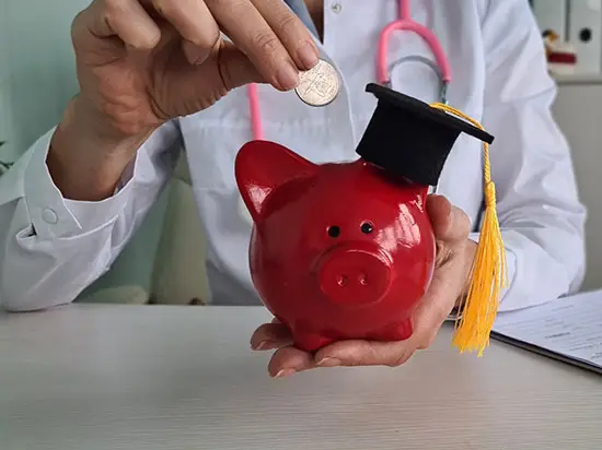 Image of doctor putting money in a piggy bank