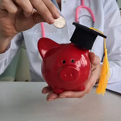Image of piggy bank with graduation cap