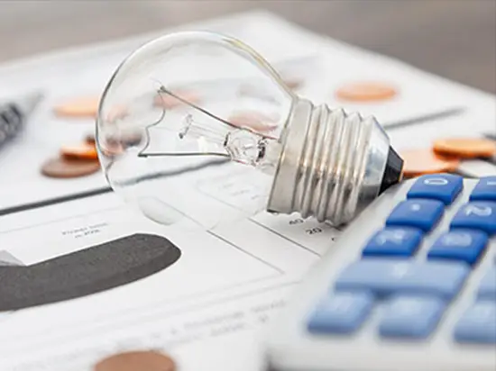 Image of a lightbulb on top of bills