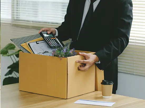 Image of employee packing personal effects into a box