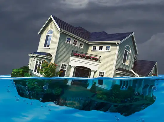 Image of house sinking in water