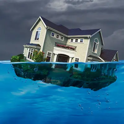 Image of house sinking in water