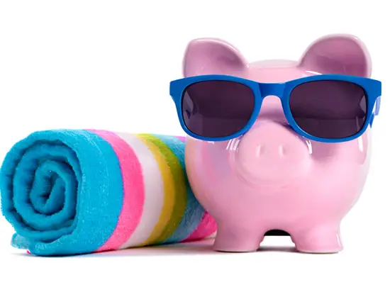 Image of piggy bank with sunglasses and a towel