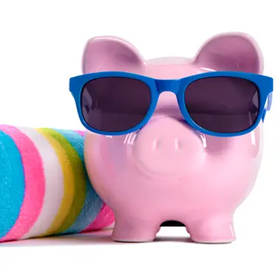 Image of piggy bank wearing sunglasses with towel