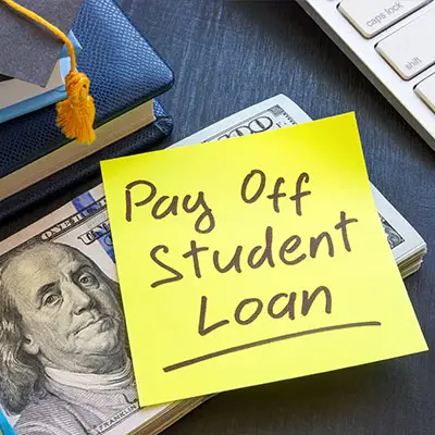 Image of post-it note with PAY OFF STUDENT LOANS written on it