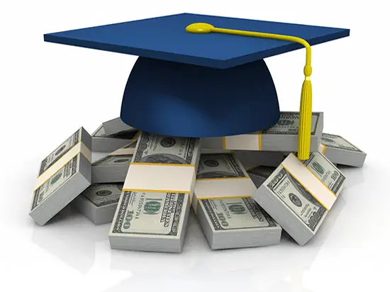 Image of graduation cap on a stack of cash