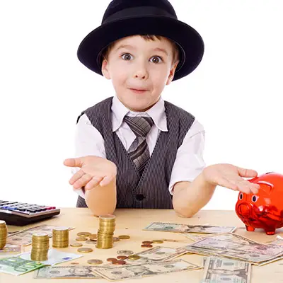 Image of boy with vest and tie playing with money