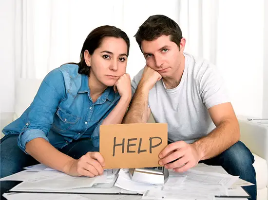 Image of couple holding a HELP sign together