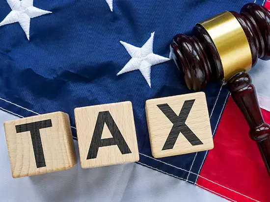Image of the words TAX on American Flag background