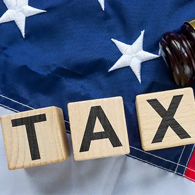 Image of TAX in front of American flag